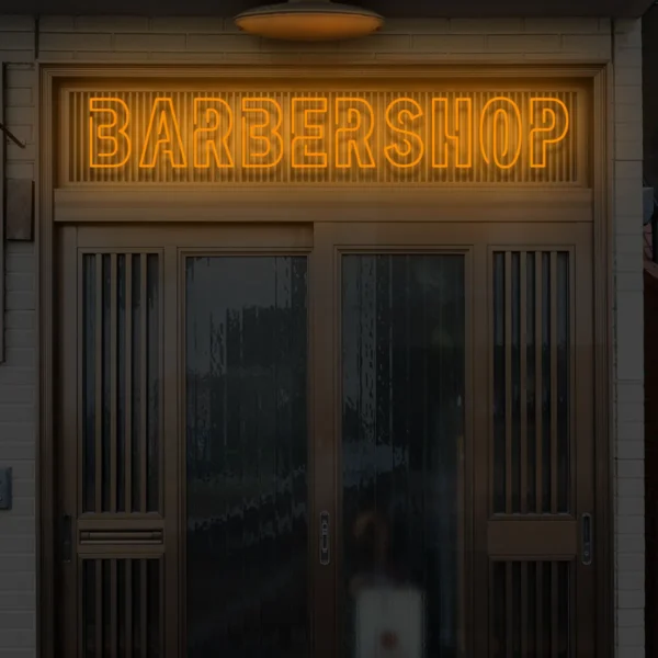 Pomarańczowy neon BARBERSHOP ozdoba świetlna nad drzwiami